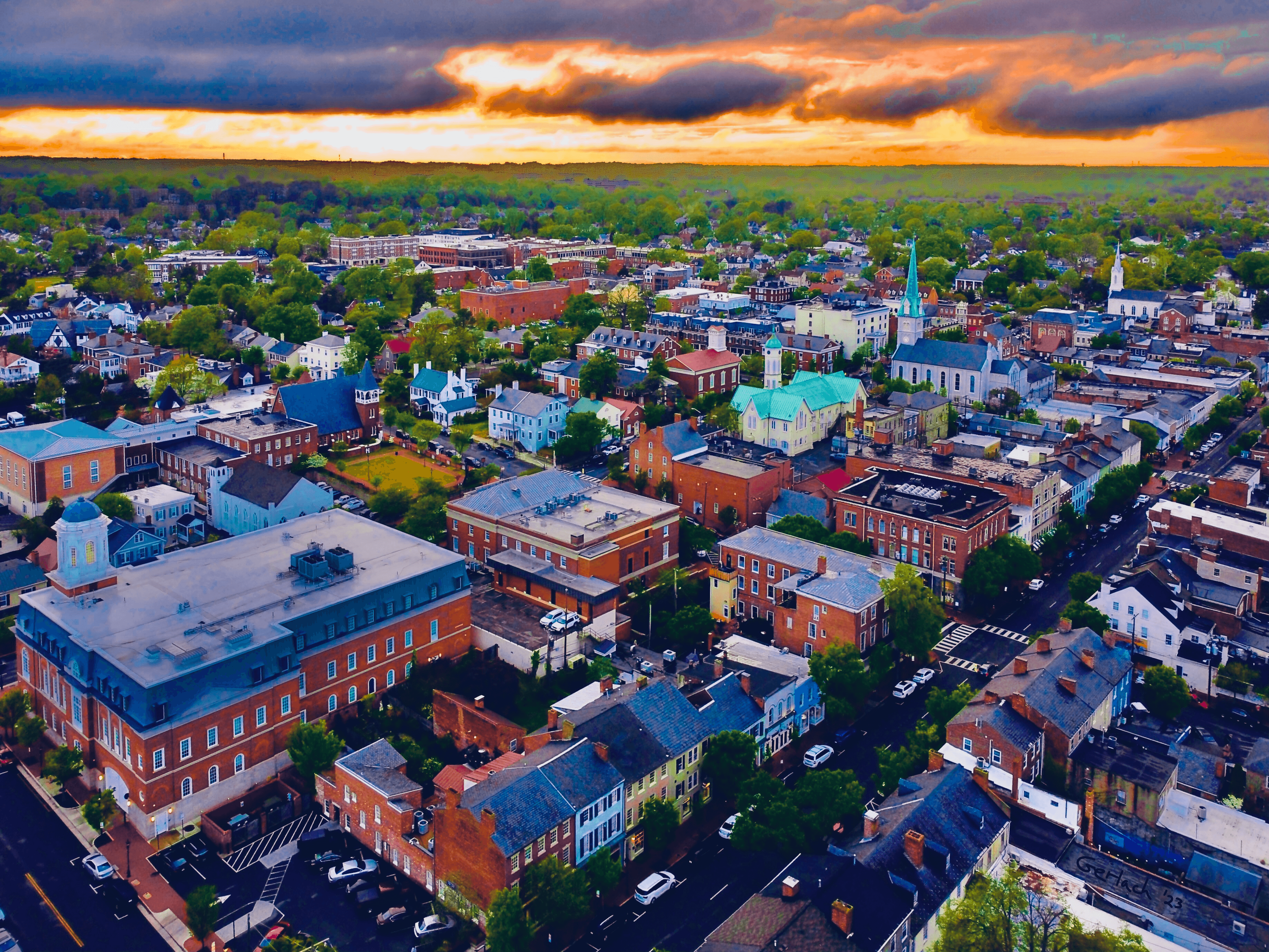 Aerial view of historic downtown Fredericksburg featuring the iconic railroad bridge over the Rappahannock River